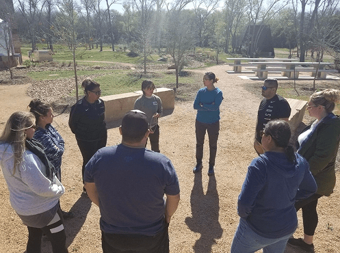 People standing in a circle at park