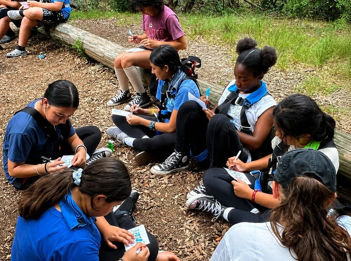 Group of girls doing crafts outdoors
