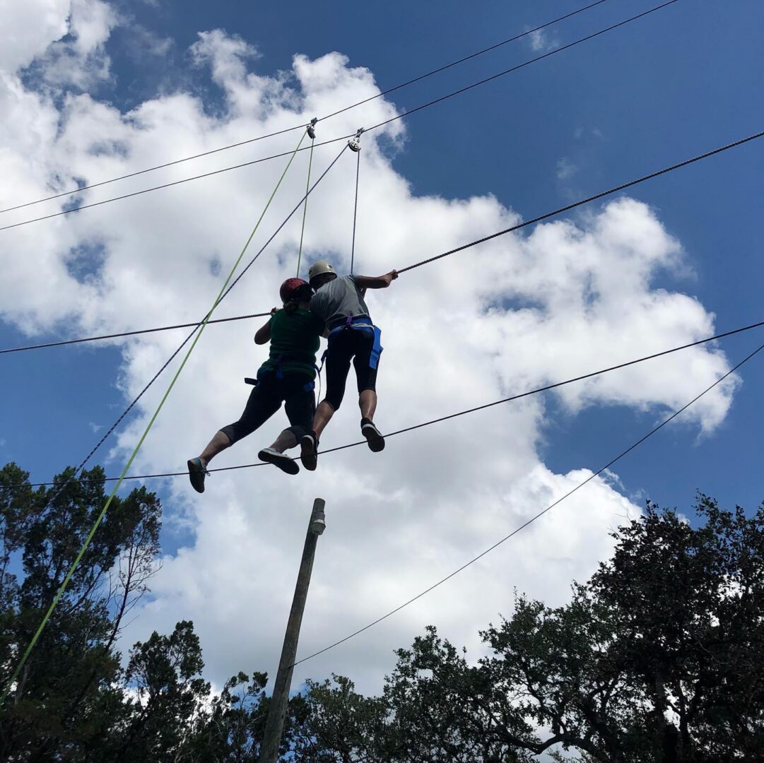 Two people on high ropes course