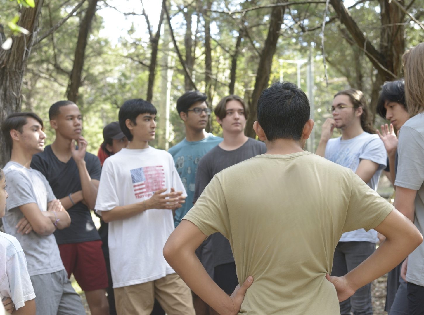 Group of young people talking in woods